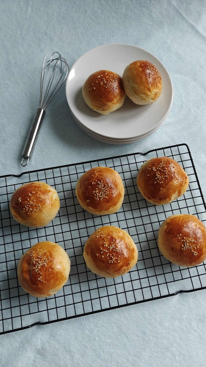 Golden sesame buns stuffed with savory meatball filling